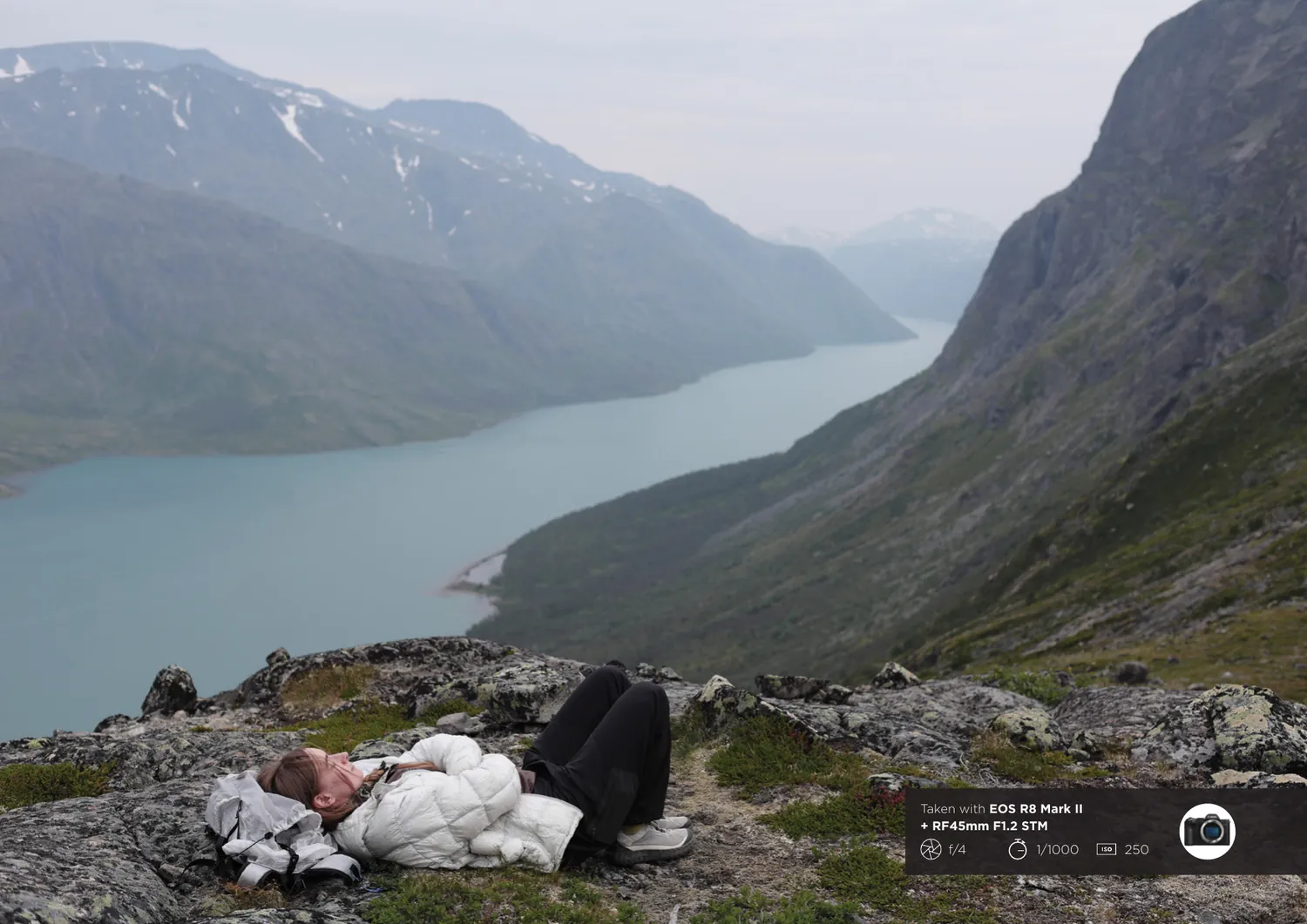 EOS R8 Mark II semi-permanent sheet, reverse: a full-bleed landscape photograph of a walker resting above a fjord, with the capture settings noted in the corner